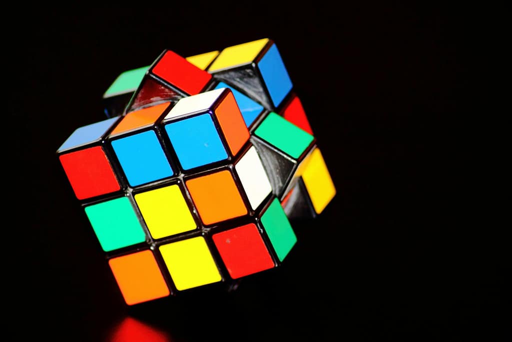 Blog A close-up of a colorful Rubik's Cube puzzle, showcasing concentration and play.