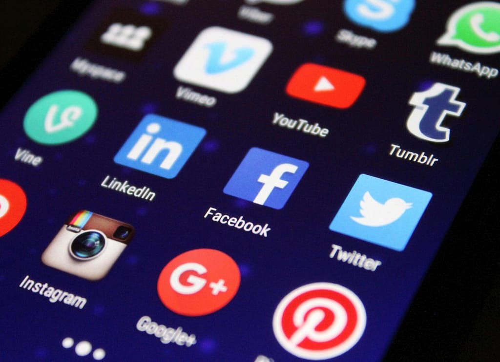 The Frontiers of Mind and Machine: Consciousness, Computing, and Our Technological Future Close-up of a smartphone screen showing various social media app icons such as Facebook and Twitter.