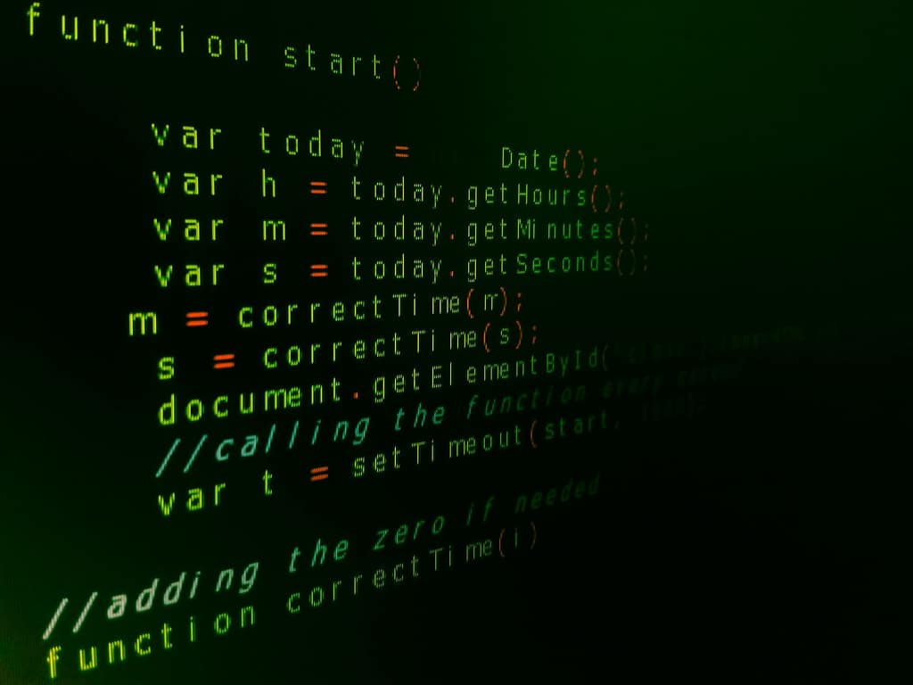 Blog Close-up of JavaScript code on a computer screen with green text highlighting syntax.