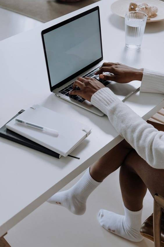 pexels photo 5076522 5076522 A woman working on a laptop in a modern home office setting, capturing a cozy and productive atmosphere.